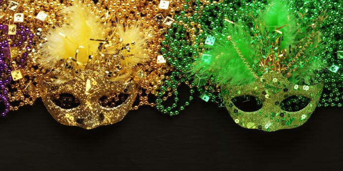 Gold and Green Mardi Gras beads and masks background