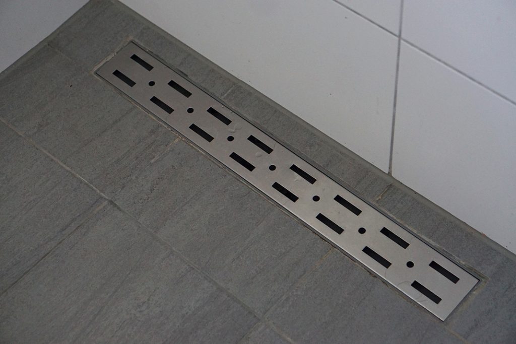 How close to the tile wall can a linear drain be placed? TileLetter