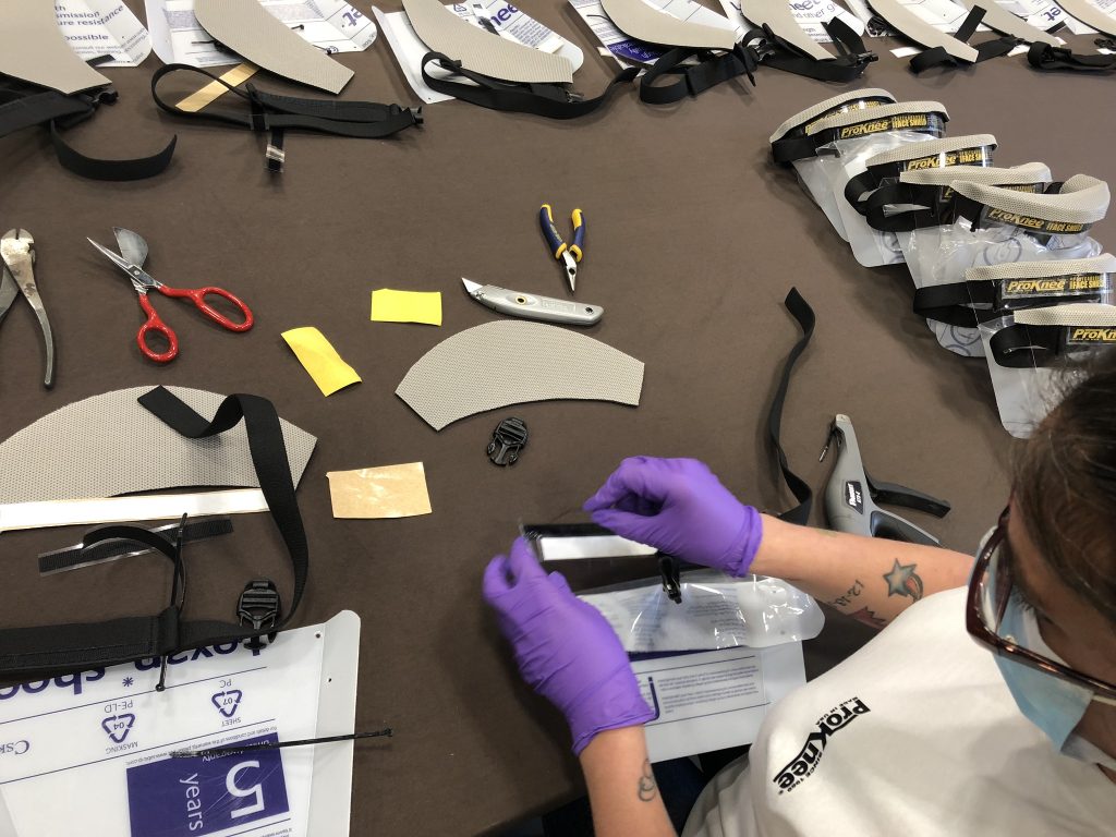 Worker assembling a ProKnee face shield
