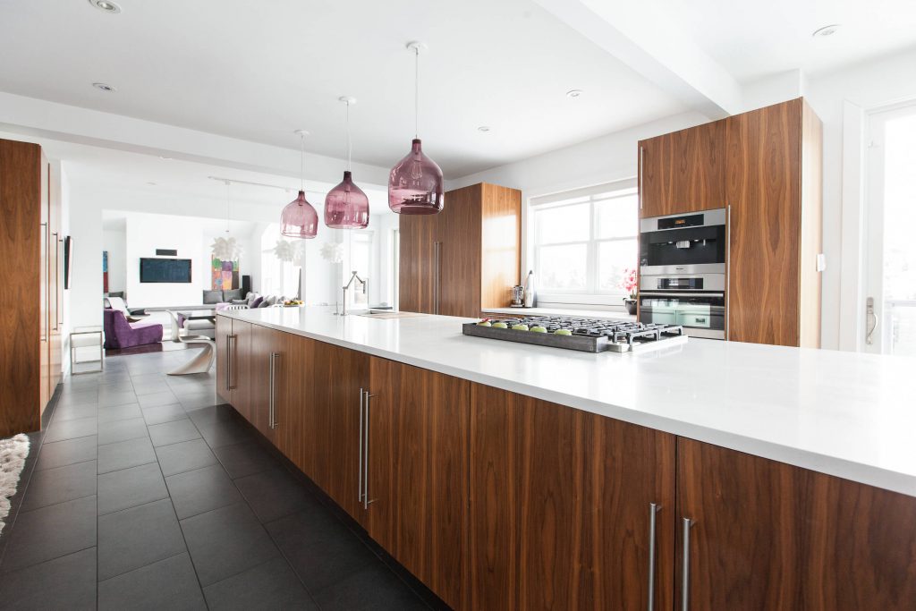 Kitchen Island with lots of wood cabinetry and tile floor

