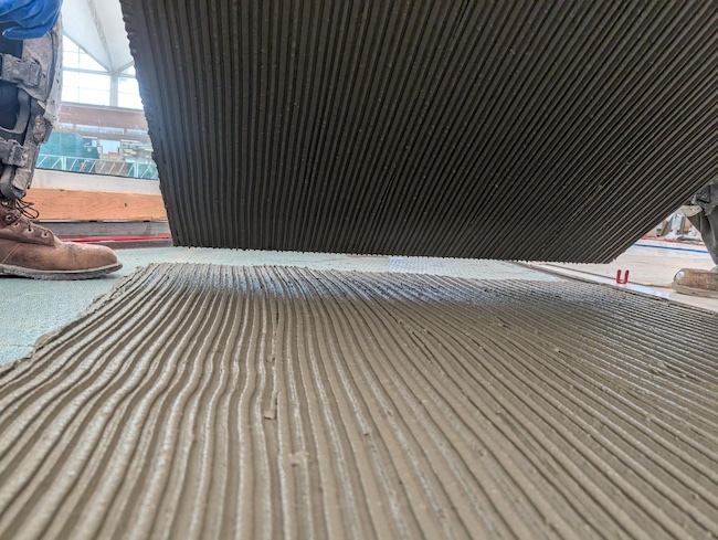 According to ANSI A108.5, tile mortar ridges must be parallel. Per this tile, ANSI A108.19 and ANSI 108.20 installation was required by the tile mortar manufacturer