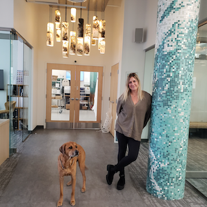 Ariel Schuster, Artaic Director of Sales & Design, with a furry friend at the Artaic office.