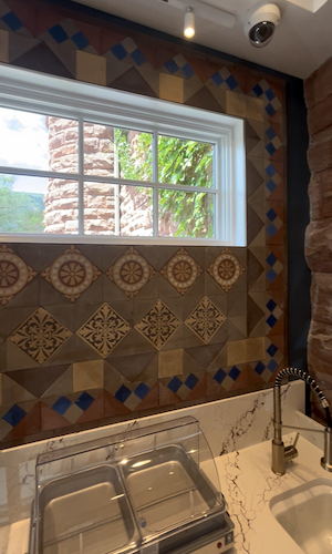 HR Tile installed this vintage-look backsplash in the kitchen area of the bathhouse.